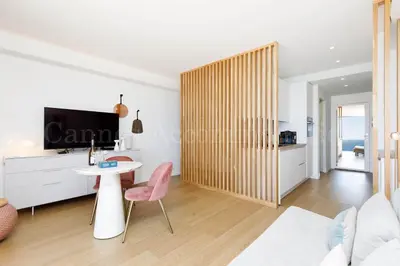 a living room with a table and a tv at Kiss in Cannes