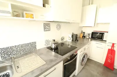 a kitchen with a sink and a washing machine at 1 bedroom with direct view to the Old Port 267 in Cannes