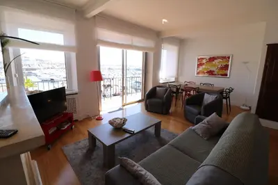 a living room with a couch and a tv at 1 bedroom with direct view to the Old Port 267 in Cannes