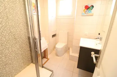 a bathroom with a toilet and a sink and a shower at 1 bedroom with direct view to the Old Port 267 in Cannes