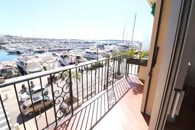 a balcony with a view of a marina at 1 bedroom with direct view to the Old Port 267 in Cannes