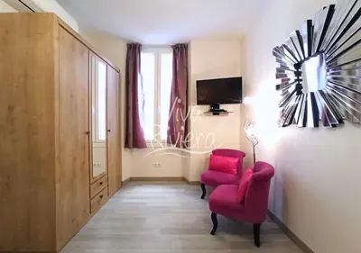 a living room with two red chairs and a tv at Calm and Modern 1 Bedroom City Centre Cannes in Cannes