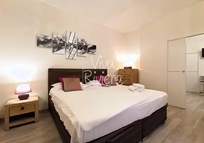 a bedroom with a large bed with white sheets at Calm and Modern 1 Bedroom City Centre Cannes in Cannes
