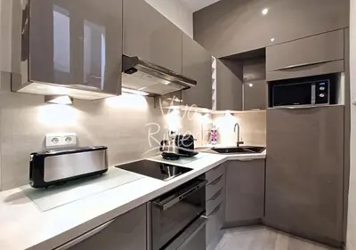 a kitchen with a sink and a microwave at Calm and Modern 1 Bedroom City Centre Cannes in Cannes