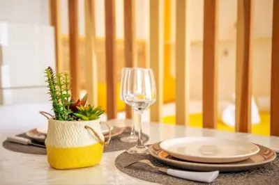 a table with a plate and a glass of wine at Cocoon Center - Rue d'antibes - 200m plage- Clim - wifi - Unique in Cannes