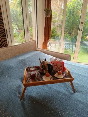 a tea set on a coffee table on a couch at Résidence Chantemerle in Cannes