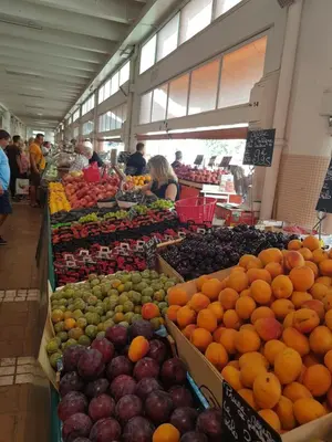 a market filled with lots of fruits and vegetables at Résidence Chantemerle in Cannes