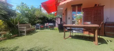 a patio with a table and chairs and an umbrella at Résidence Chantemerle in Cannes