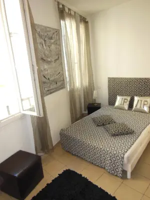 a bedroom with a bed and a large window at 1 Bedroom Joffre 2 mins from Palais des Festivals 263 in Cannes