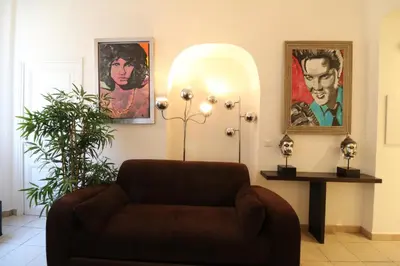 a living room with a couch and posters on the wall at 1 Bedroom Joffre 2 mins from Palais des Festivals 263 in Cannes