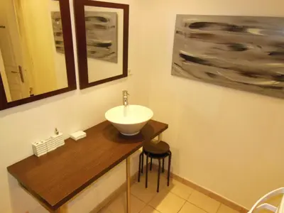 a bathroom with a sink on a wooden counter with a sink at 1 Bedroom Joffre 2 mins from Palais des Festivals 263 in Cannes