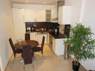 a kitchen with a table and chairs in a room at 1 Bedroom Joffre 2 mins from Palais des Festivals 263 in Cannes