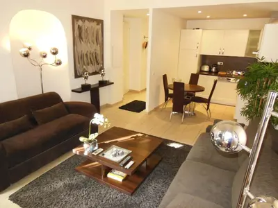 a living room with a couch and a table at 1 Bedroom Joffre 2 mins from Palais des Festivals 263 in Cannes