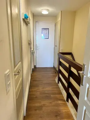 a hallway with a white door and a wooden floor at Cannes Villa Francia in Cannes