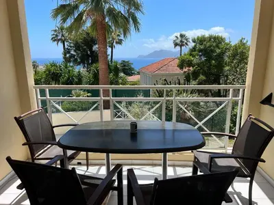 a table and chairs on a balcony with a view of the ocean at Cannes Villa Francia in Cannes