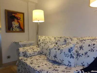 a blue and white couch in a living room with a lamp at B&B Villa Feline in Cannes
