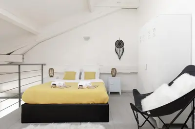 a bedroom with two beds and two chairs at Doris YourHostHelper in Cannes