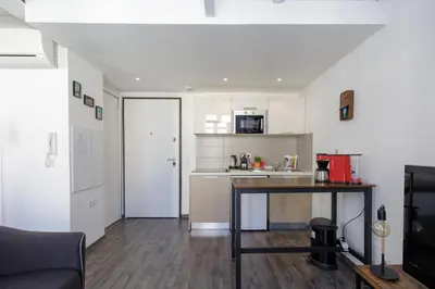 a living room with a table and a kitchen at Doris YourHostHelper in Cannes