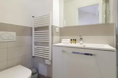 a bathroom with a sink and a toilet and a mirror at Doris YourHostHelper in Cannes
