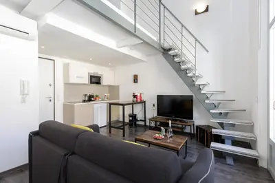 a living room with a couch and a staircase at Doris YourHostHelper in Cannes