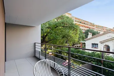 a balcony with a bench and a view of a city at Appartement Maréchal - Welkeys in Cannes