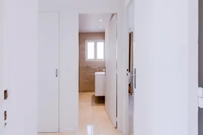 a bathroom with a white door and a toilet at 2Br 3 min from the center & the Croisette in Cannes