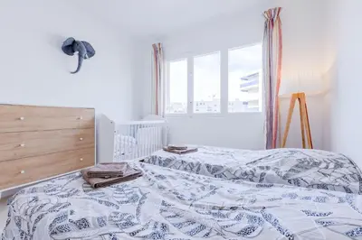 a bedroom with a bed and a window at 2Br 3 min from the center & the Croisette in Cannes