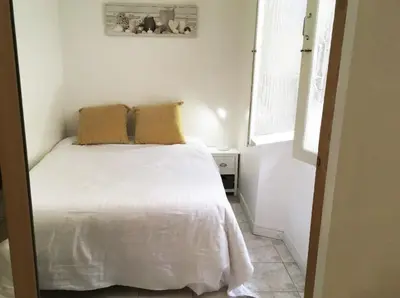 a bedroom with a white bed with two pillows on it at C087-Comfortable apartment in the heart of Cannes in Cannes