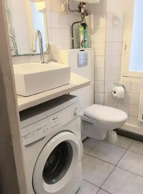 a bathroom with a washing machine and a sink at C087-Comfortable apartment in the heart of Cannes in Cannes