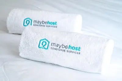 two rolls of white towels sitting on a bed at C087-Comfortable apartment in the heart of Cannes in Cannes