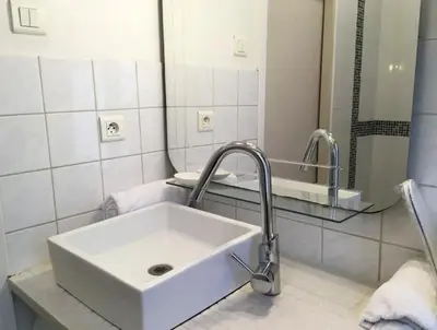 a bathroom with a white sink and a mirror at C087-Comfortable apartment in the heart of Cannes in Cannes