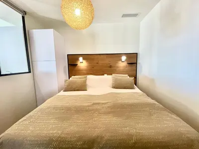 a bedroom with a large bed in a room at Gallia Park by Welcome to Cannes in Cannes