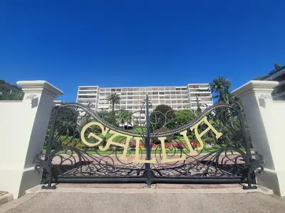 a gate with the word garden on it in front of a building at Gallia Park by Welcome to Cannes in Cannes