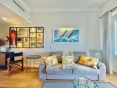 a living room with a couch and a table at Gallia Park by Welcome to Cannes in Cannes