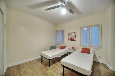 a room with two beds and a ceiling fan at Confortable 2 chambres MEYNADIER-FORVILLE A2B105 in Cannes