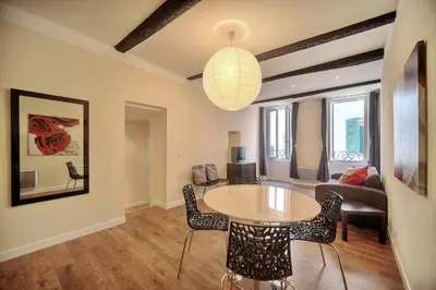 a living room with a table and chairs at Confortable 2 chambres MEYNADIER-FORVILLE A2B105 in Cannes