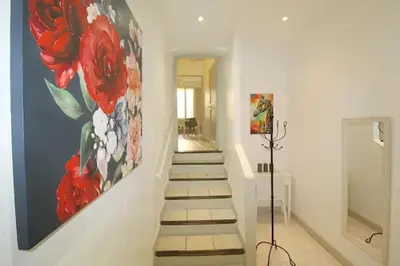 a stairway with a painting of flowers on the wall at Appartement confortable à Cannes avec climatisation - 53 m² in Cannes