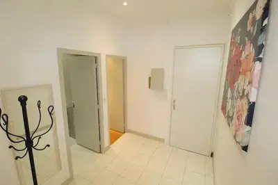 a hallway with two doors and a tile floor at Appartement confortable à Cannes avec climatisation - 53 m² in Cannes