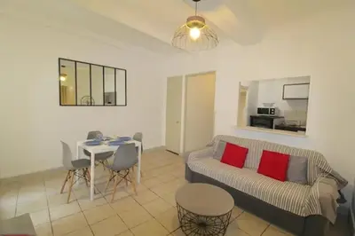 a living room with a couch and a table at Appartement confortable à Cannes avec climatisation - 53 m² in Cannes