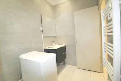 a bathroom with a toilet and a sink and a mirror at Appartement confortable à Cannes avec climatisation - 53 m² in Cannes