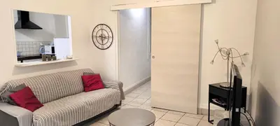 a living room with a couch and a television at Appartement confortable à Cannes avec climatisation - 53 m² in Cannes