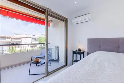 a bedroom with a bed and a balcony at 1-Br Apartment 5 min on foot from the Croisette in Cannes