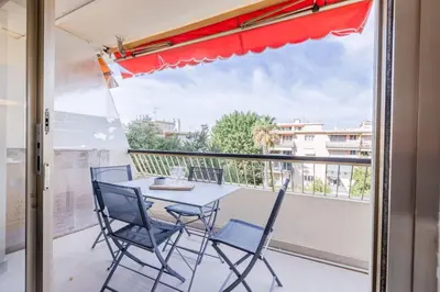 a patio with a table and chairs on a balcony at 1-Br Apartment 5 min on foot from the Croisette in Cannes