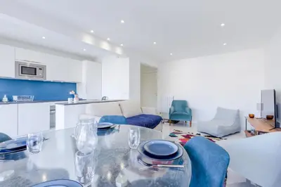 a kitchen and living room with a table and chairs at 1-Br Apartment 5 min on foot from the Croisette in Cannes