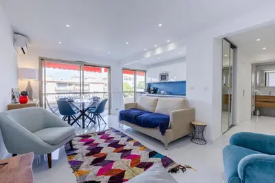 a living room with a couch and a table at 1-Br Apartment 5 min on foot from the Croisette in Cannes