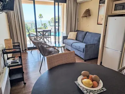 a living room with a table and a couch at Apartment Villa Francia-6 by Interhome in Cannes