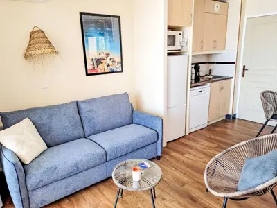 a living room with a blue couch and a table at Apartment Villa Francia-6 by Interhome in Cannes