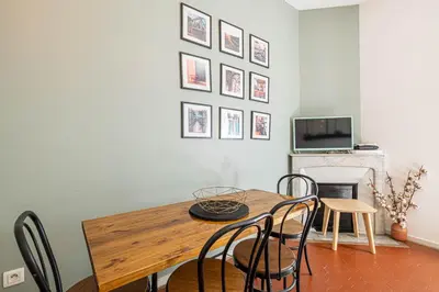 a dining room with a wooden table and chairs at Luxurious flat in the heart of Cannes in Cannes