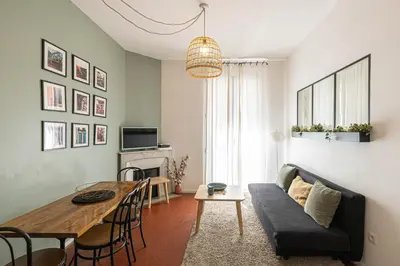 a living room with a couch and a table at Luxurious flat in the heart of Cannes in Cannes