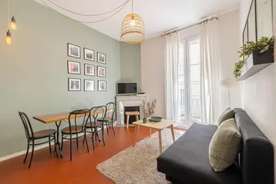 a living room with a couch and a table at Luxurious flat in the heart of Cannes in Cannes